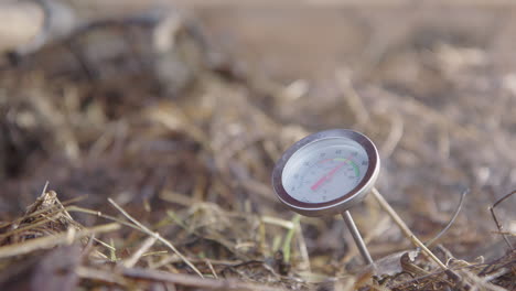 ZOOM-IN,-SLOW-MOTION---steam-rises-around-the-compost-thermometer