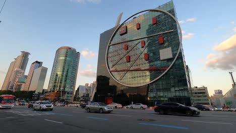 Modern-architecture-of-the-HDC-office-block-building-in-Seoul,-South-Korea,-car-traffic-timelapse-on-Yeongdong-daero-road-at-sunset
