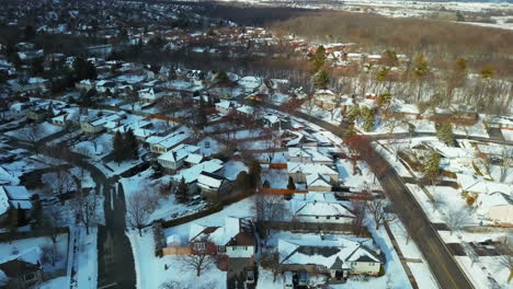 Clouds-cast-a-shadow-in-a-winter-aerial-over-a-suburban-neighborhood