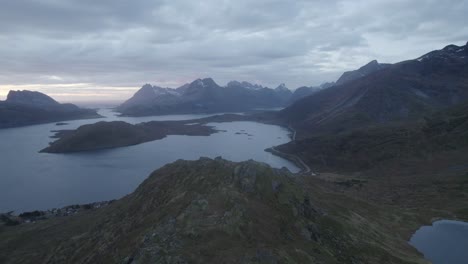 Aerial-view-overlooking-a-mountainous-fjord,-dark,-gloomy-fall-day-in-Lofoten,-Norway