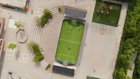 Tiny-green-football-field-in-school-yard-in-Solna,-Stockholm