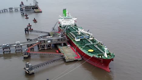 Silver-Rotterdam-oil-petrochemical-shipping-tanker-loading-at-Tranmere-terminal-Liverpool-aerial-view-reverse-orbit-left