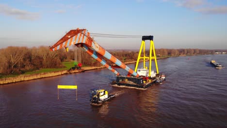 Aerial-View-Of-Tug-Boat-Pulling-Hebo-Lift-9-Floating-Crane-Along-Oude-Maas