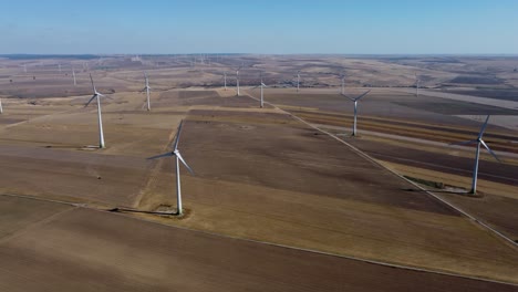 Wind-turbines-spread-out-over-vast-area-on-wind-park,-aerial-shot