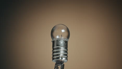 Close-up-of-a-Tungsten-Filament-Light-Bulb-and-Macro-Shot-of-Electronic-Components-on-Turn-Table