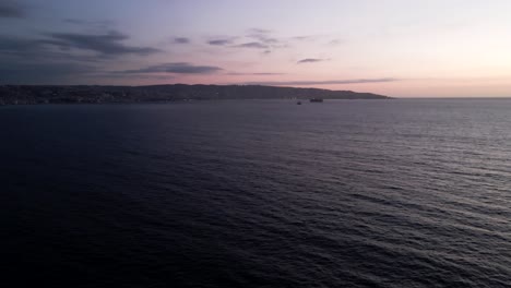 Aerial-view-of-a-sunset-at-sea-with-Valparaiso-in-the-background