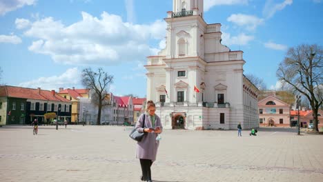 Tourist-Exploring-Kaunas-City-Landmarks-On-A-Beautiful-Day---close-in-medium-shot