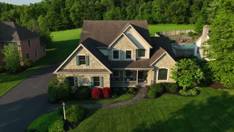 Aerial-reverse-shot-of-large-American-home-in-expensive-neighborhood