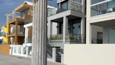 Variety-of-Luxury-Houses-along-Santa-Monica-Beach-Front,-California,-passing-shot