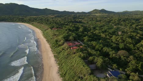 Long-video-of-aerial-orbit-around-beach-front-resort-at-Ventanas-beach-in-Costa-Rica