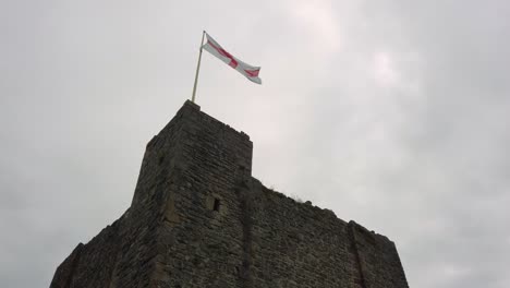 St-George-Cross-flag-waving-on-top-of-gothic-castle-turret-silhouette