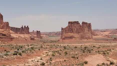 Arches-National-Park,-Three-Gossips-Rock-Formation-and-Desert-Road-in-Courthouse-Towers-Area,-Moab,-Utah-USA