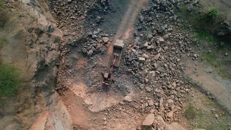 Top-down-aerial-view-of-Excavators-loading-rocks-into-a-portable-rock-crusher