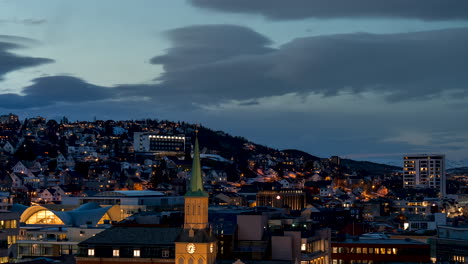 Twilight-time-lapse-of-Tromso-city-settling-in-for-the-night,-Norway