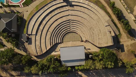 A-dynamic-pivoting-aerial-shot-above-the-Villa-Maria-amphitheater-in-Córdoba-City-of-Argentina-while-it-gradually-descends-to-it
