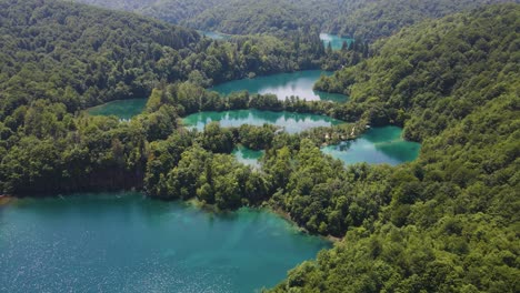 Incredible-view-of-the-beautiful-Plitvice-Lakes-National-Park-with-many-green-plants-and-beautiful-lakes-and-waterfalls-drone-flight
