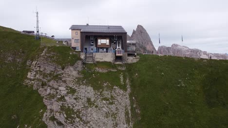 Cable-Car-Station-at-Seceda-Mountain-Peak,-Urtijei,-South-Tyrol,-Italian-Alps,-Dolomites,-Italy---Aerial-Drone-View