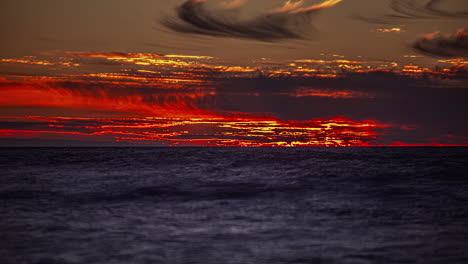 Timelapse-shot-of-majestic-sunset-over-cloudscape-sky-over-the-sea-water