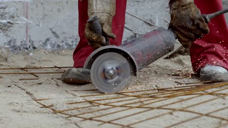 Hands-with-abrasive-saw-cutting-construction-iron