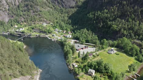 Vikafjord-channel-leading-to-river-Vosso-and-school-building-along-road-FV569---Voss-salmon-river-Reverse-aerial