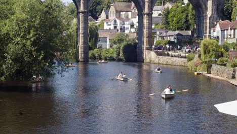People-having-fun-in-rowing-boats-on-the-river-Nidd-Knaresborough-Yorkshire-England-UK-during-summertime