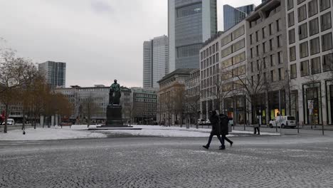 People-Walk-At-Rossmarkt-During-Winter-With-Commerzbank-Tower-And-Skyline-In-Background-In-Frankfurt-am-Main,-Germany