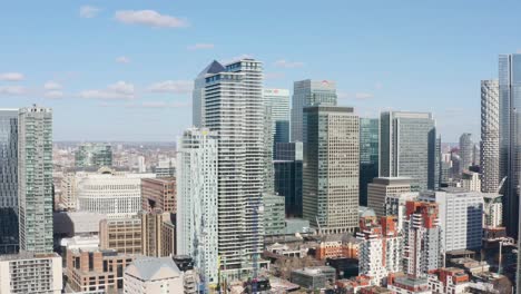 Drone-shot-into-centre-of-canary-wharf-skyscrapers-sunny-day