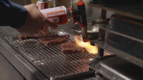 Close-up-on-torching-beef-stake-on-a-grill