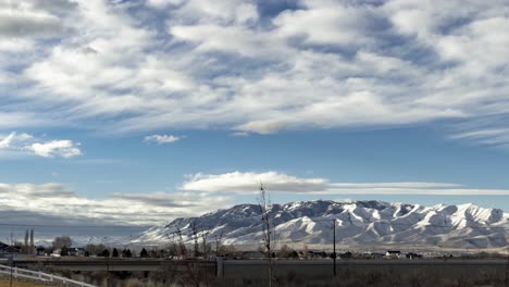 Dynamic-cloudscape-above-a-snow-mountain-on-a-scenic-day---static-wide-angle-time-lapse