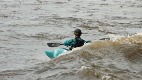Kajakfahrer-Surft-Im-Kielwasser-Einer-Welle,-Die-Von-Den-Stromschnellen-Des-Ottawa-River-Erzeugt-Wird