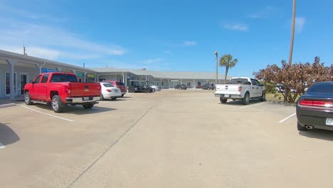 POV-driving-a-parking-lot-and-pulling-into-a-parking-space-in-a-Texas-beach-town-on-Mustang-Island