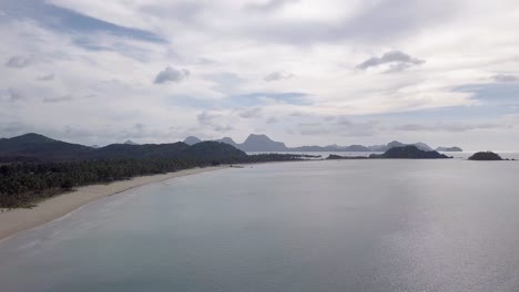 4K-Aerial-Drone-View-of-White-Sandy-Beach-on-a-Tropical-Island-Nacpan-Beach-in-El-Nido,-Palawan,-Philippines