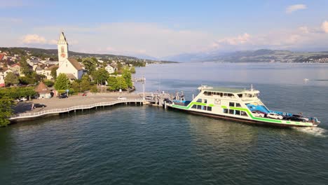 Aerial-drone-shot-flying-towards-car-ferry-waiting-in-Meilen,-Switzerland