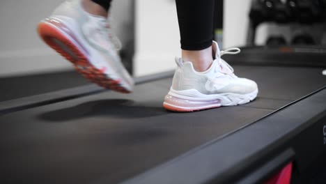 Female-Wearing-Nike-Tennis-Shoes-Walking-on-Treadmill-to-Exercise,-Closeup