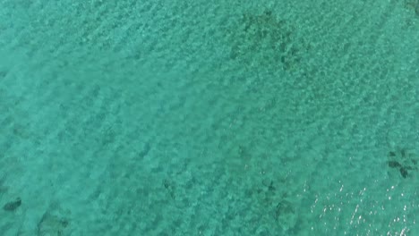 Revealing-luxury-Eafonissi-beach-resort-in-island-of-Crete,-drone-tilting-up-view