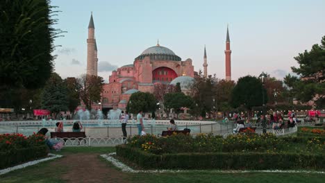 Wide,-evening-clip-of-people-relaxing-in-front-of-Hagia-Sophia,-Istanbul