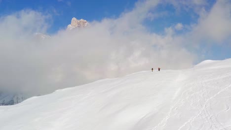 Isolated-group-of-hikers-on-top-of-snow-capped-Dolomites-mountain