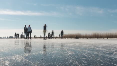 Dutch-ice-skaters-on-frozen-canal-in-Netherlands,-time-lapse