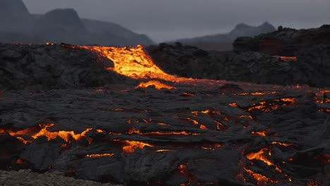 Stream-of-incandescent-lava-flowing-in-desolated-landscape