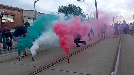 Kids-play-in-the-colorful-smoke-on-the-tracks,-representing-the-colors-of-the-Italian-flag,-Corso-Italia,-Toronto