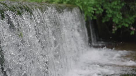 Weir-in-river,-close-pan-shot-over-river-in-rural-Japan