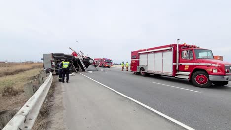 Truck-accident-spot-with-fire-brigade-vehicle-and-policemen---tracking-dolly-shot