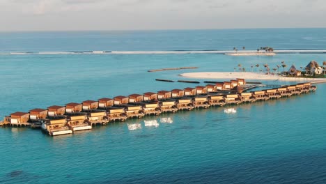 resort-blue-lagoon-white-sand-beach-maldives-scenery-at-sunset-over-the-water-villas