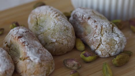 Camera-moving-over-a-wooden-board-with-chewy-pistachio-amaretti-Christmas-cookies