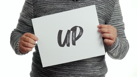 A-person-holding-a-sign-with-the-message-and-the-word-"up