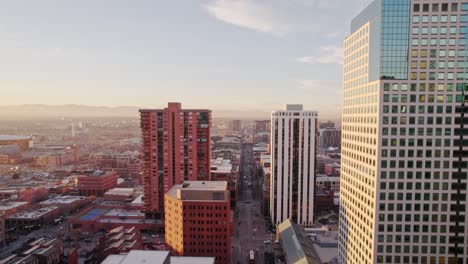 Drone-Aerial-View-Of-Downtown-Denver-Colorado-Flying-Backwards-Showing-Lannies-Clock-Tower-On-Arapahoe-Street-During-Golden-Hour-Sunset