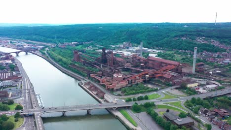 Aerial-view-of-abandoned-steel-factory-with-urban-background