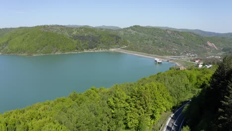 Maneciu-Reservoir-Surrounded-By-Mountain-Foliage-With-Asphalt-Road-In-Prahova-County,-Muntenia,-Romania