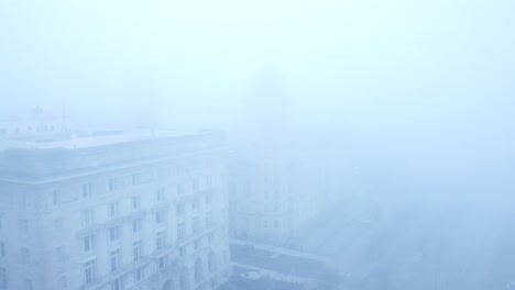 Thick-dense-ghostly-fog-cover-across-Liverpool-city-aerial-view-of-surreal-downtown-waterfront-forward-descent