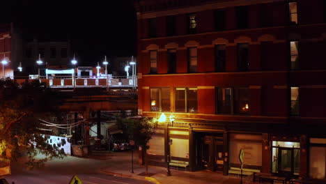 A-dolly-zoom-shot-of-a-old-motel-building-next-to-a-rail-train-station-in-the-old-streets-of-Chicago-late-at-night